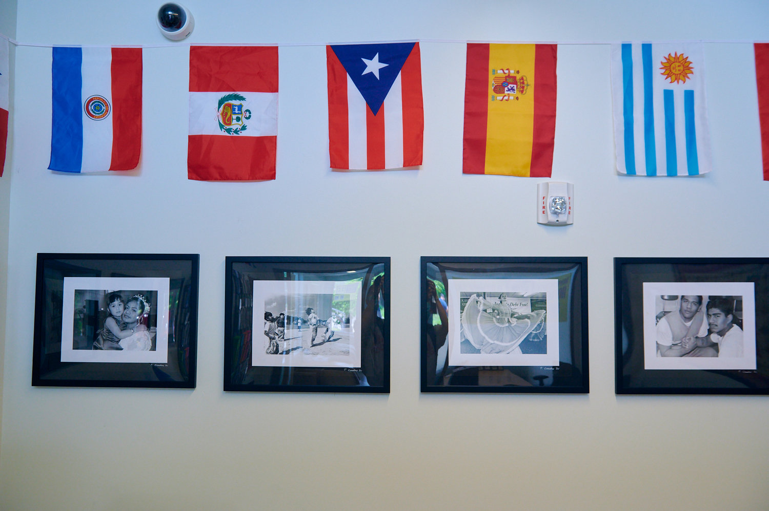 An abundance of flags and photos decorate the walls of the Liaison's new Sanford office. 'We really wanted to be able to showcase what we represent and be able to really show that we are a community agency, that we serve immigrants of different nations matter where they come from,' said deputy director Hannia Benitez about the flags, 'and that's who El Vinculo Hispano is.'